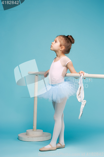 Image of The little balerina dancer on blue background