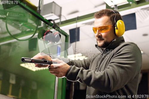 Image of The man at the shooting range.