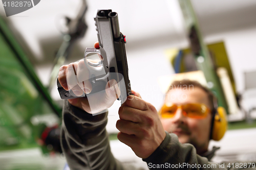 Image of Shooting a gun at a shooting range.