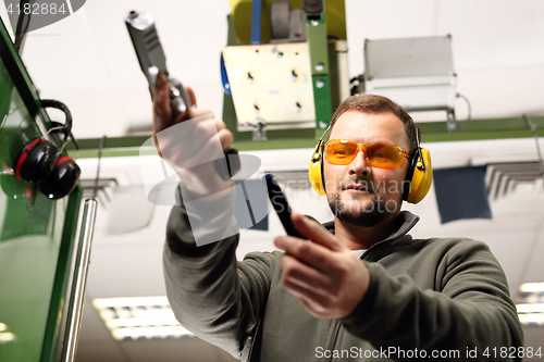 Image of Shooting a gun at a shooting range.