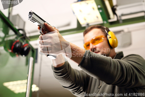 Image of Gun. Sport shooting range. The man at the shooting range.