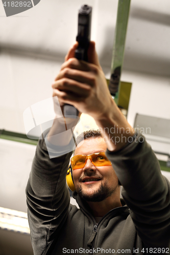 Image of The man at the shooting range. Science use of firearms.