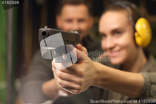 Image of Glock, woman shoots at the shooting range