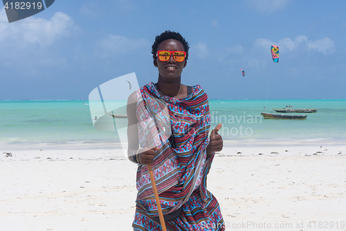 Image of Traditonaly dressed black man on Paje beach, Zanzibar, Tanzania, East Africa.