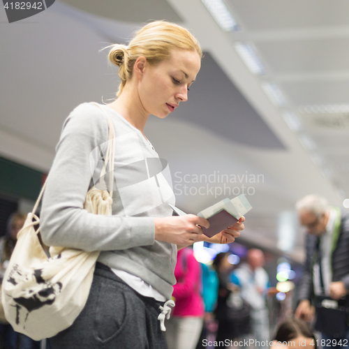 Image of Casual woman waiting for her flight at airport.