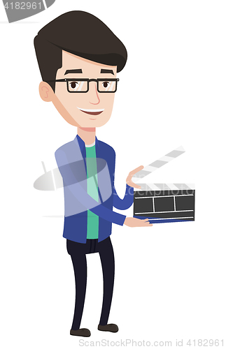 Image of Smiling man holding an open clapperboard.