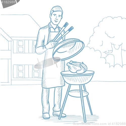 Image of Man cooking chicken on barbecue grill.