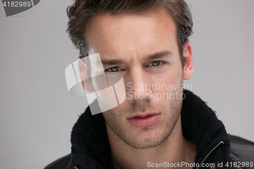 Image of portrait of a young guy over gray background