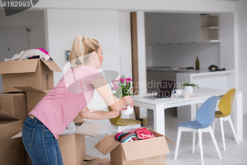 Image of girl moving in the new apartment