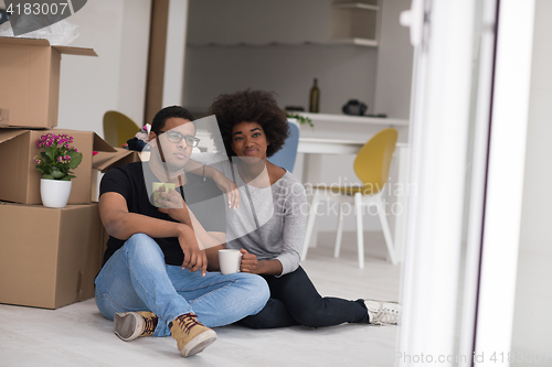 Image of African American couple relaxing in new house