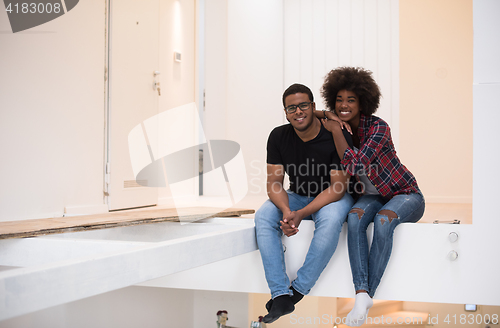 Image of couple having break during moving to new house