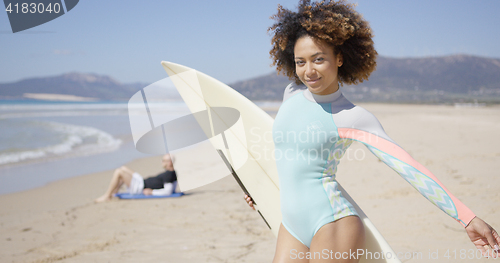 Image of Female posing with surfboard