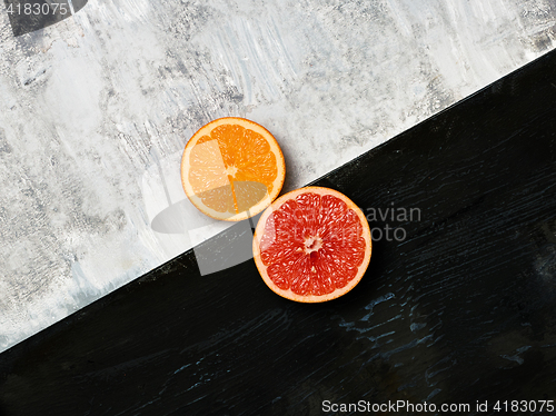 Image of Grapefruit citrus fruit halves on wooden