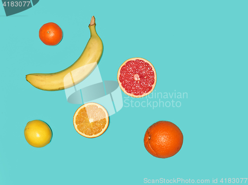 Image of The group of banana and fresh fruits against blue background