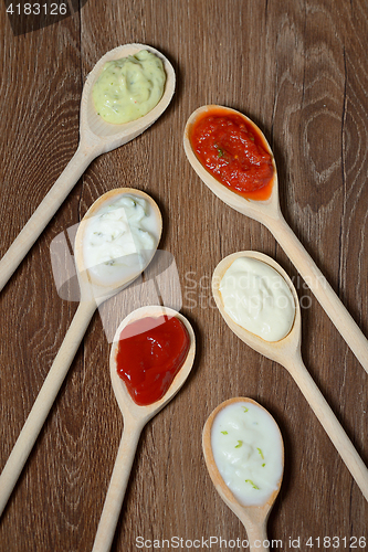 Image of different types of sauces in spoons