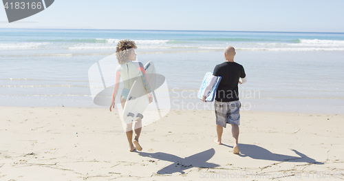 Image of People walking to the ocean