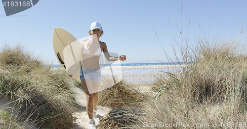 Image of Woman running with the surfboard