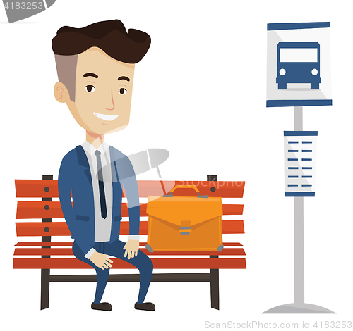 Image of Businessman waiting for bus at the bus stop.