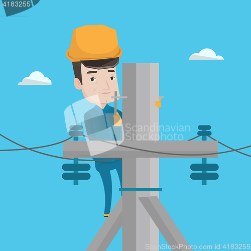 Image of Electrician working on electric power pole.