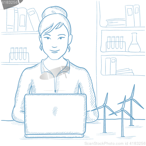 Image of Woman working with model wind turbines on table.