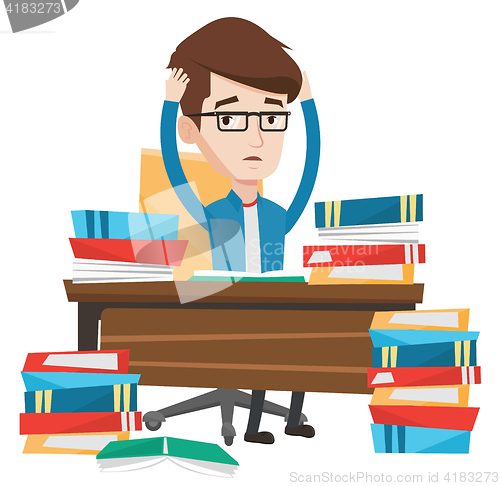 Image of Student sitting at the table with piles of books.