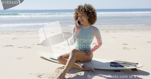 Image of Female talking on phone on beach