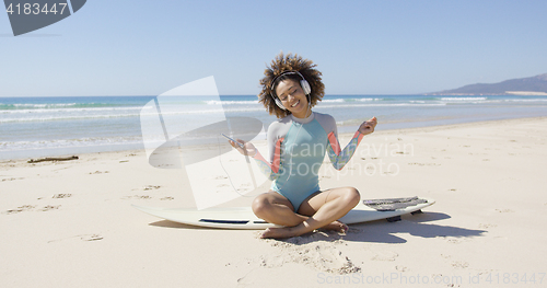 Image of Female listening music on sea background