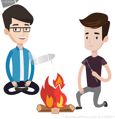 Image of Two friends sitting around bonfire.