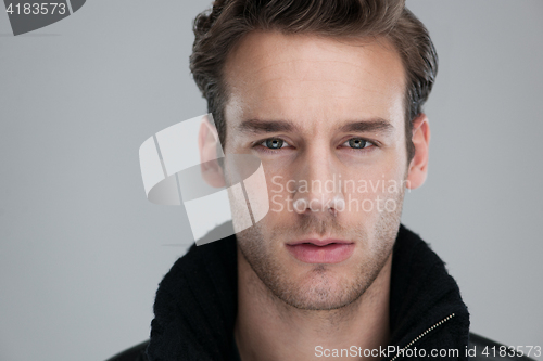 Image of portrait of a young guy over gray background