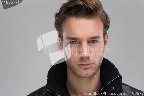 Image of portrait of a young guy over gray background