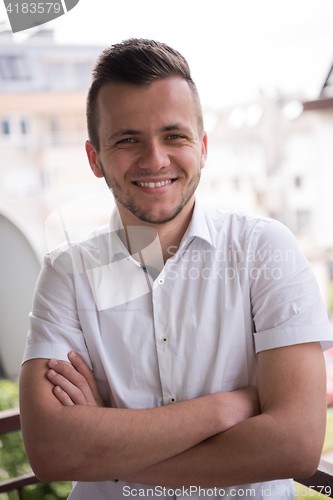 Image of man standing at balcony