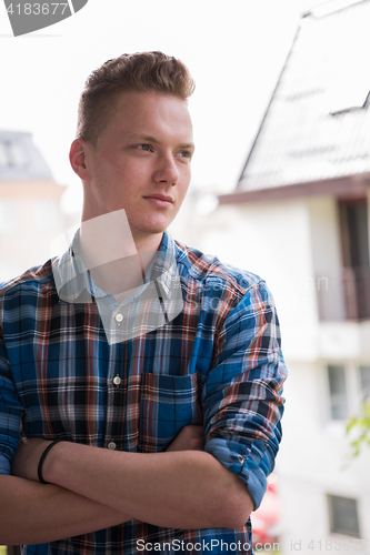 Image of man standing at balcony