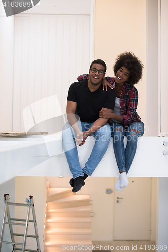 Image of couple having break during moving to new house