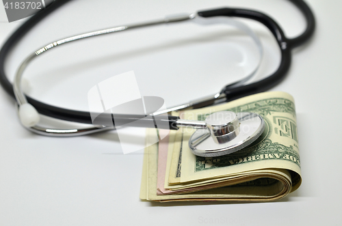 Image of Stethoscope sitting on US dollar bills