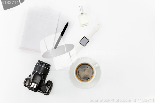 Image of Coffee and personal items on desktop