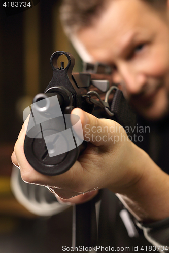 Image of Military exercises on the firing range The soldier fires a rifle at the shooting range