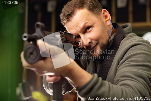 Image of Military exercises on the firing range The soldier fires a rifle at the shooting range