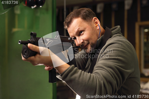 Image of Military exercises on the firing range The soldier fires a rifle at the shooting range