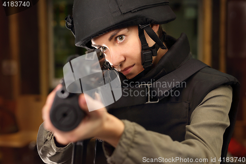 Image of Woman shoots a rifle at the shooting range Policewoman at the shooting range with a rifle shot