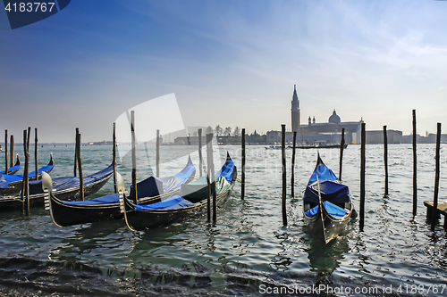 Image of Gondolas moored in front of Saint Mark square with San Giorgio d