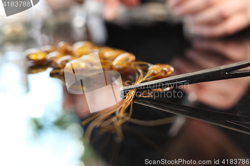 Image of Amber jewelry Manufactory, a woman carries jewelry made of amber