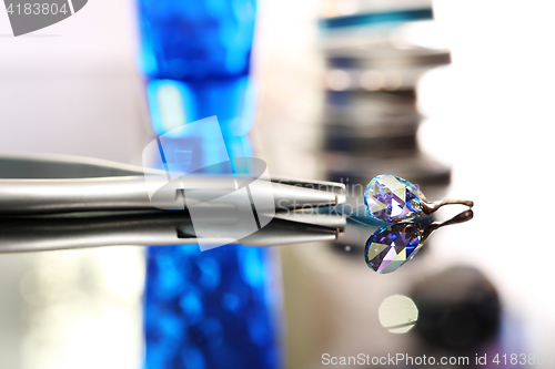 Image of Jewelry, Swarovski crystal Woman hands a jeweler while working on jewelery