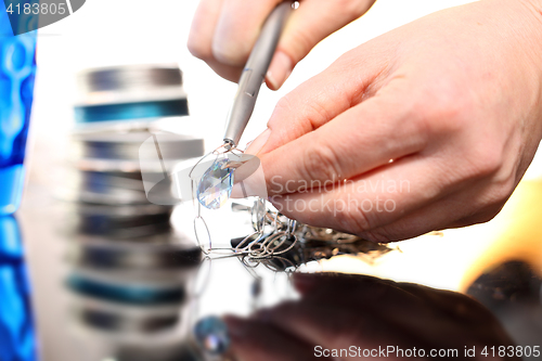 Image of Jeweler, goldsmith while working on silver jewelry