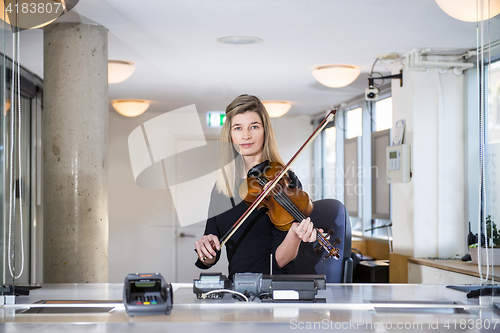 Image of Classical Musician behind ticket counter