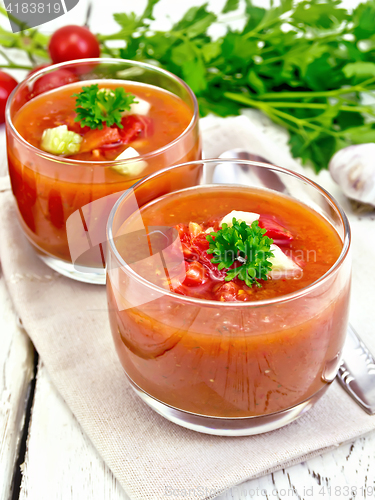 Image of Soup tomato in two glasses with parsley on napkin