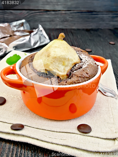 Image of Cake chocolate with pear in red bowl on kitchen towel