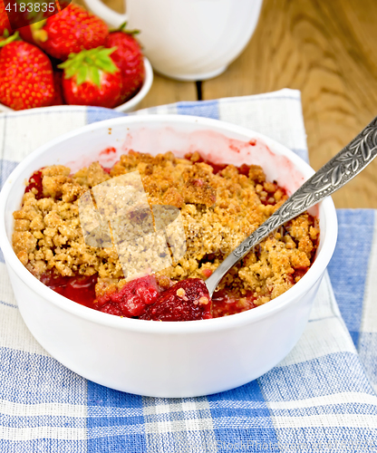 Image of Crumble strawberry in white bowl on board