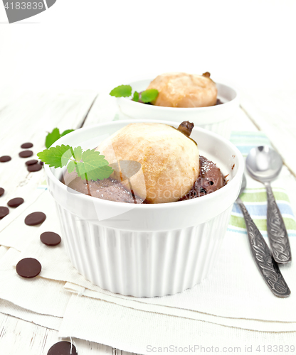 Image of Cake chocolate with pear in white bowl on light board