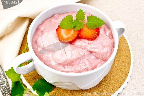 Image of Soup strawberry in bowl with napkin on granite table