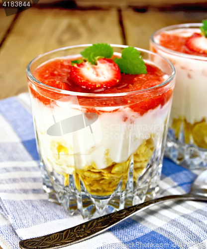 Image of Dessert milk with strawberry in glassful on board and napkin